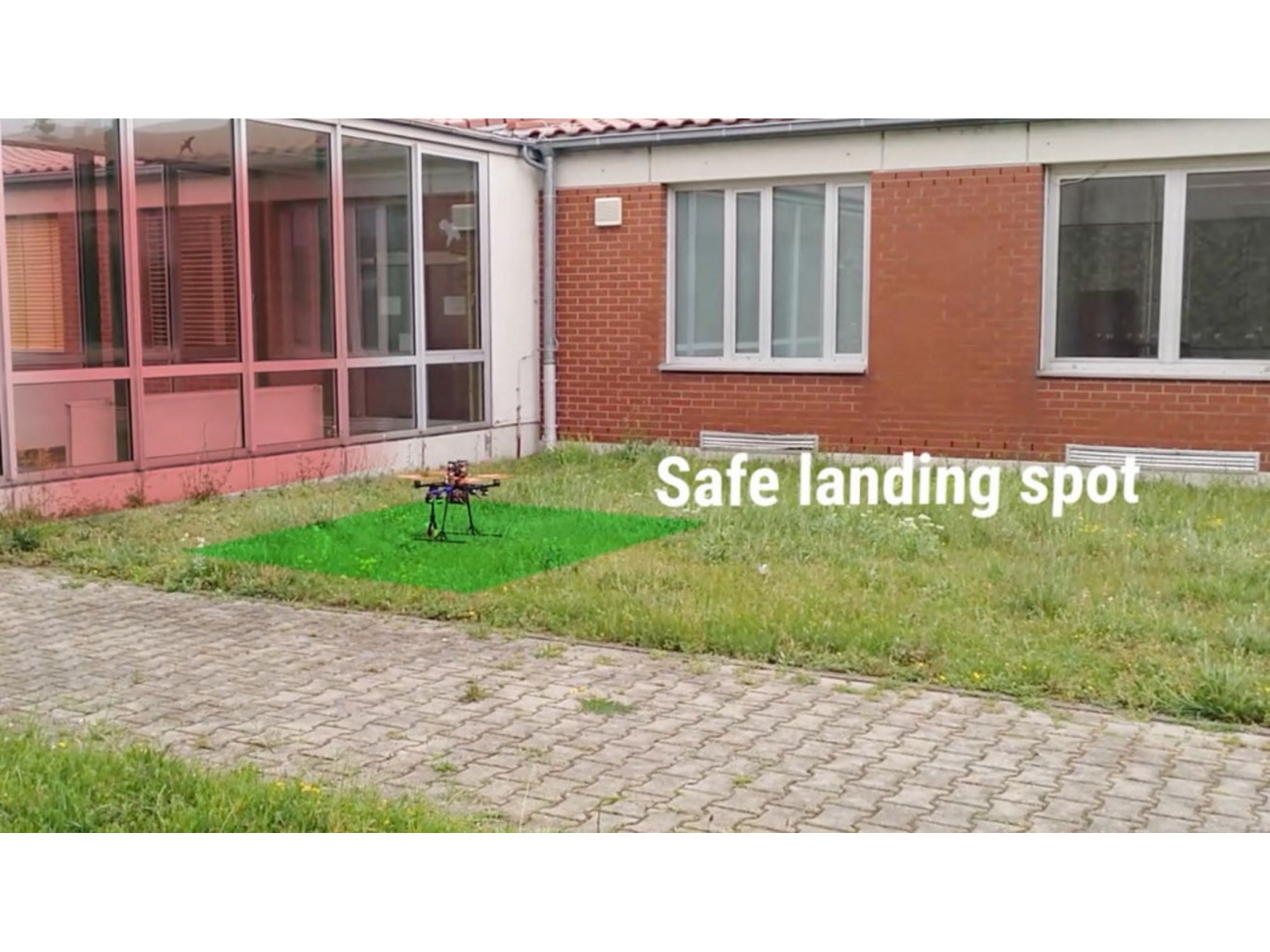 The drone detects the space between buildings as a suitable landing site